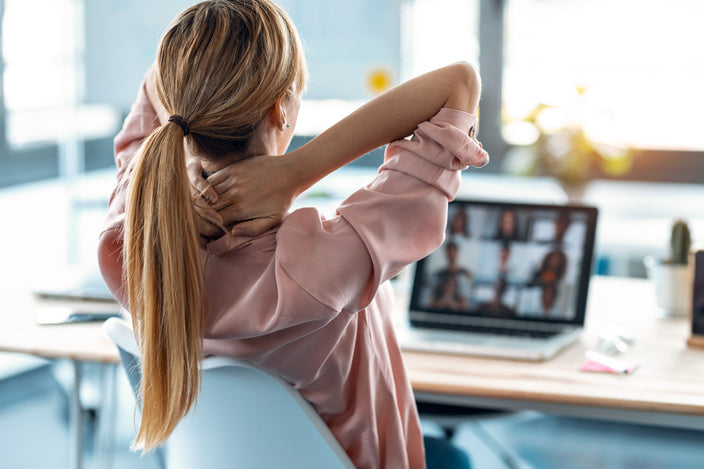 Woman with neck and shoulder pain at work